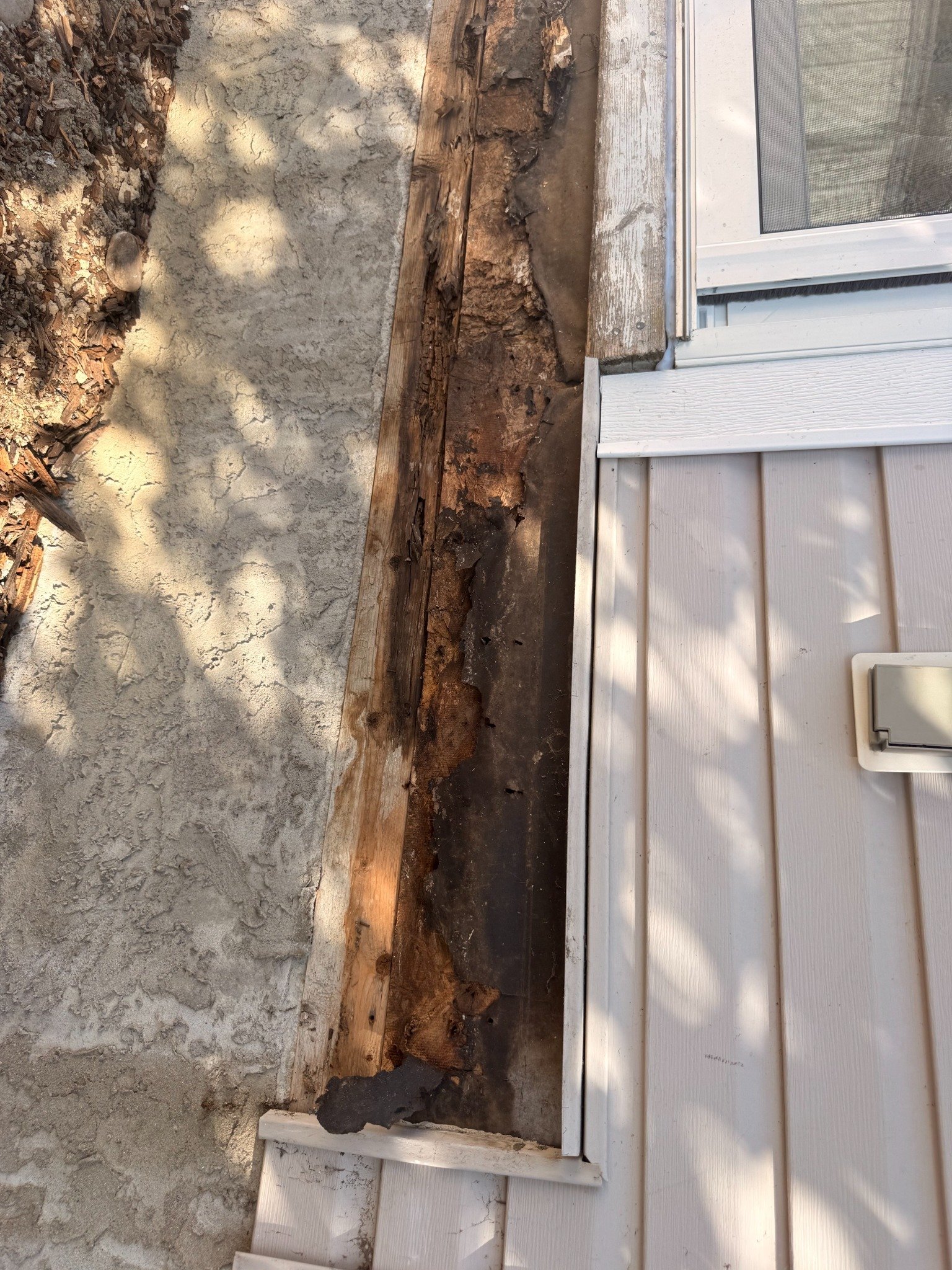 Close-up of rotted deck framing in Calgary